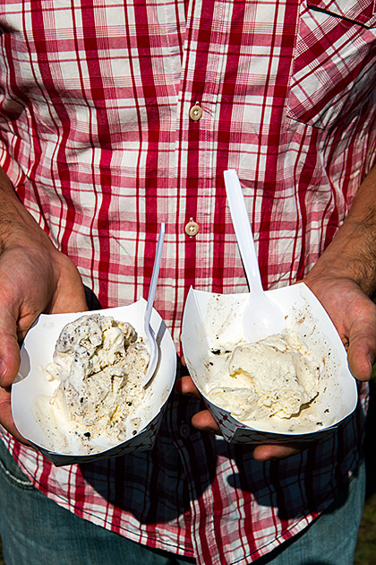 Man holding two paper bowls with ice cream